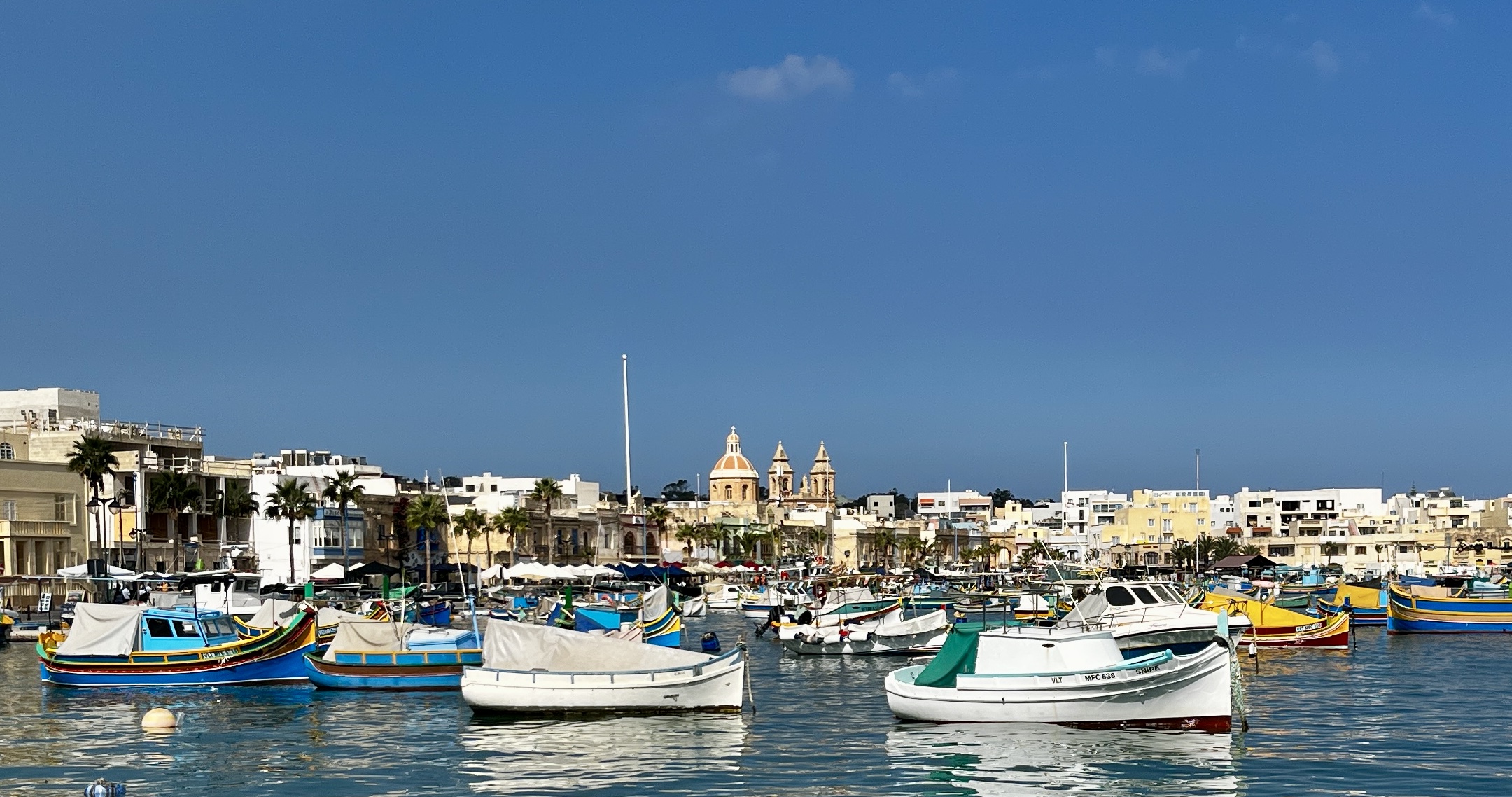 A Glimpse into Marsaxlokk's Fishing Industry: Ancient Trawlers and Skilled Fishermen